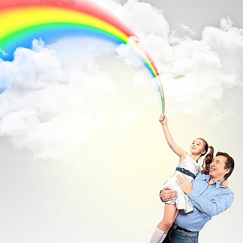 Father holding his daughter and rainbow