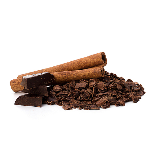 Crushed chocolate shavings pile and cinnamon sticks isolated on white