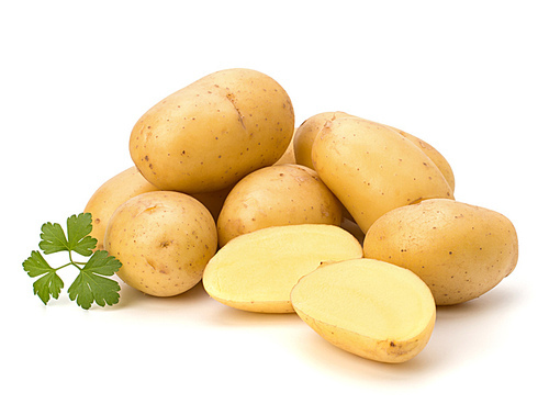 New potato and green parsley isolated on white close up