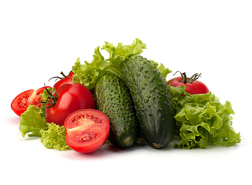 Tomato|cucumber vegetable and lettuce salad isolated on white