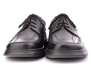 Black glossy man’s shoes with shoelaces isolated on white