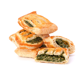 Puff pastry bun isolated on white. Healthy patty with spinach.