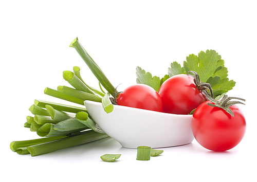 Spring onions and cherry tomato in bowl isolated on white cutout