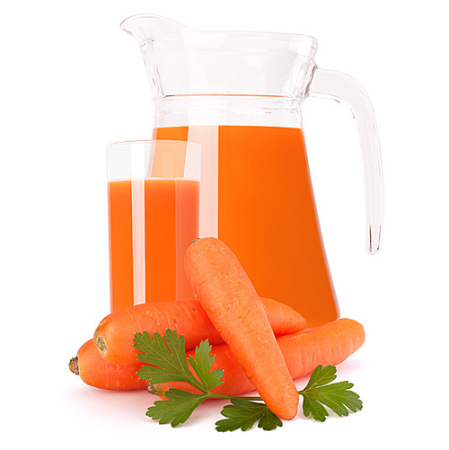 Carrot vegetable juice in glass jug isolated on white cutout