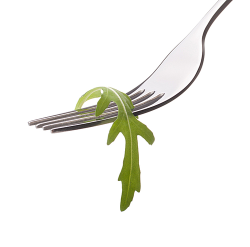 Fresh rucola  salad on fork isolated on white cutout. Healthy eating concept.