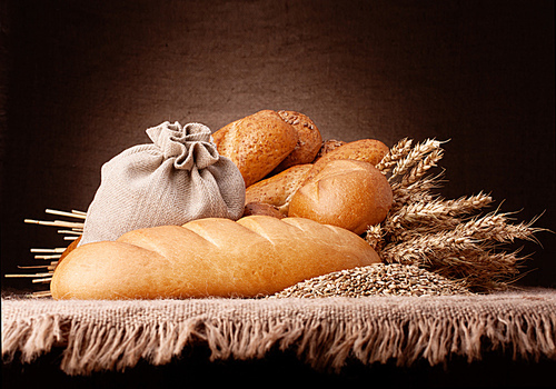 Bread|flour sack and ears bunch still life on rustic background
