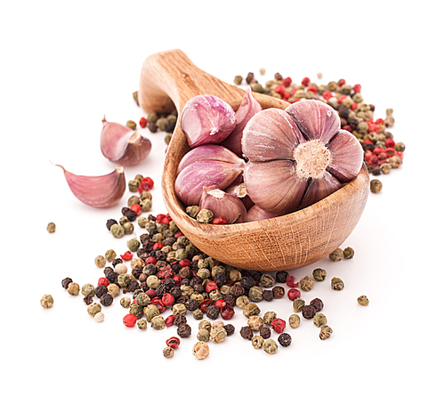 Garlic cloves in wooden bowl isolated on white