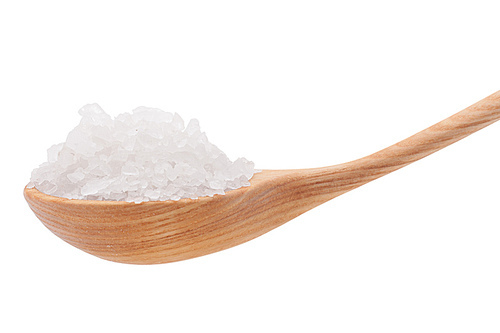 Mineral salt in wooden spoon isolated on white cutout