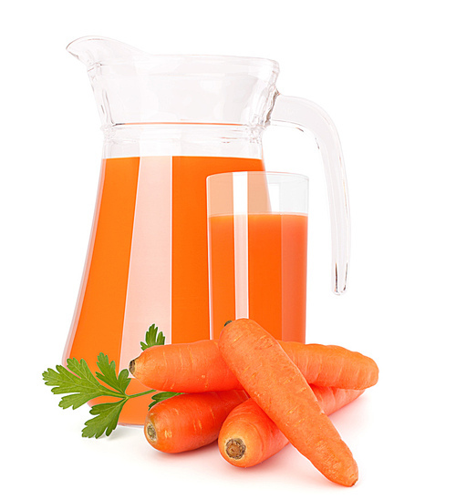 Carrot vegetable juice in glass jug isolated on white cutout