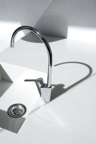 White modern kitchen detail|faucet and sink with shadows