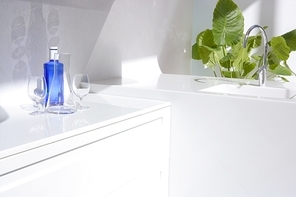 White modern kitchen|blue water bottle and plants
