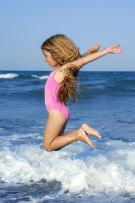 flying jump beach girl on blue sea shore in summer vacation