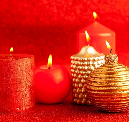 christmas candles group on red glitter background