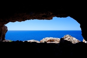 Cave hole in Barbaria Cape Formentera with mediterranean blue sea view