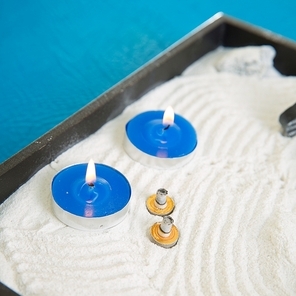 Zen little garden with blue candles and moxa for moxibustion acupunture