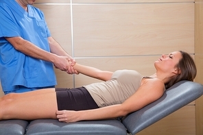 fascial therapy doctor pulling patient woman arm at hospital