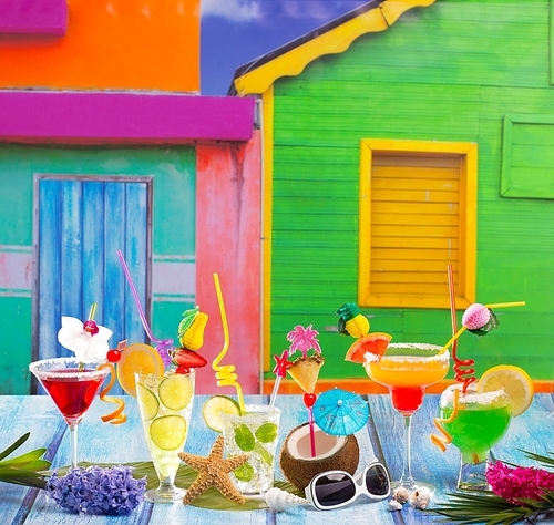 Colorful varied tropical Cocktails in tropical Caribbean house with coconut mojito pepermint margarita