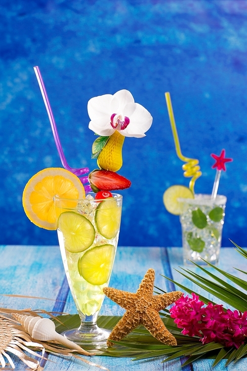 Mojito and lemon lime Cocktails in tropical Caribbean blue wood with starfish flowers and seashells