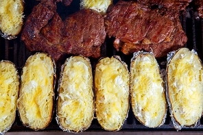 Barbecue grilled beef meat and foil potatoes prepared with cream and cheese