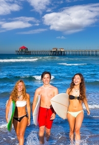 boys and 여성s teen surfers coming out from the huntington beach california