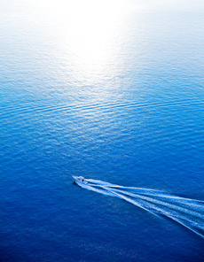 Boat cruising blue Mediterranean sea aerial view in Spain