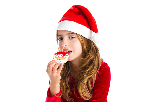 Christmas kid girl eating Xmas Santa cookie isolated on white