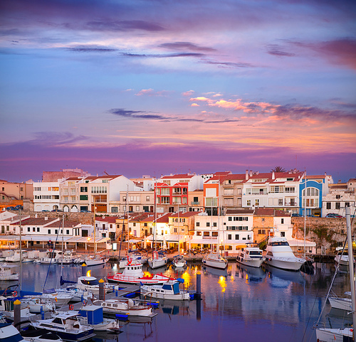 Ciutadella Menorca marina Port sunset with boats and streetlights in Balearic islands