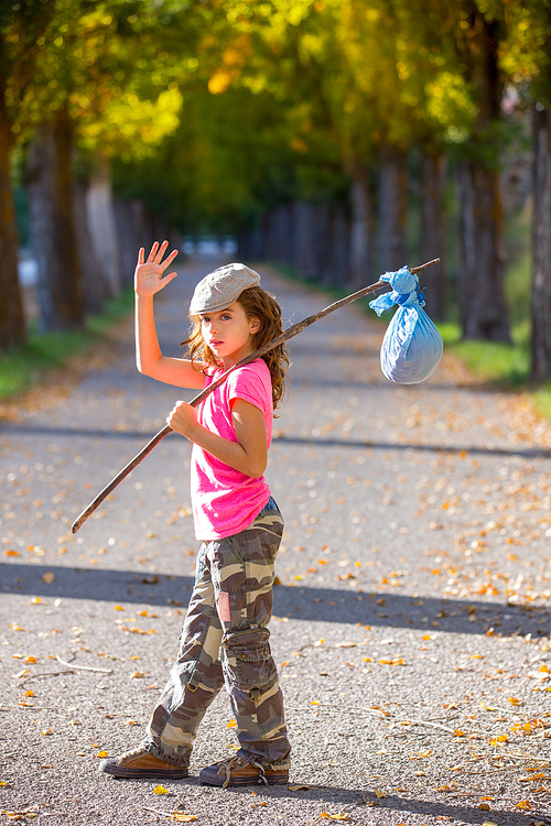 little kid with hobo stick bag and bundle girl saying goodbye with hand