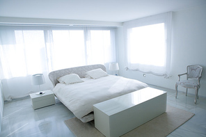 Modern white house bedroom with marble floor and luminous windows