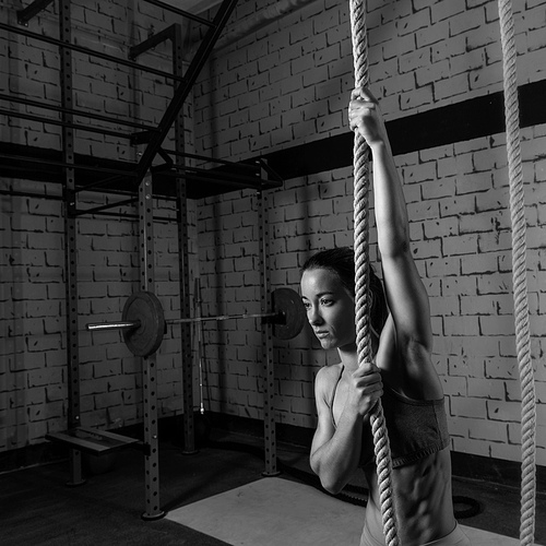 Climb rope exercise woman workout at gym