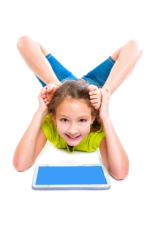 Flexible contortionist kid girl playing with tablet pc on white background