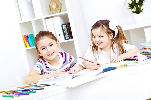 Little girl sitting and studying at home