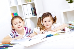 Little girl sitting and studying at home