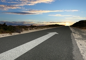 Image of road with white arrow directing forward