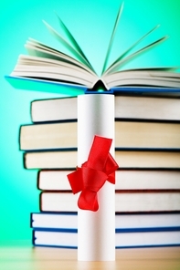 Diploma and stack of books against the background