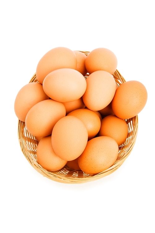 Brown eggs in the basket on white