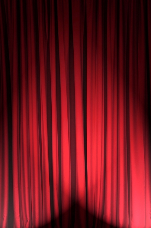 Brightly lit curtains in theatre concept