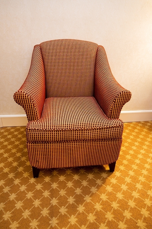 Interior of the room - modern arm chair against the wall