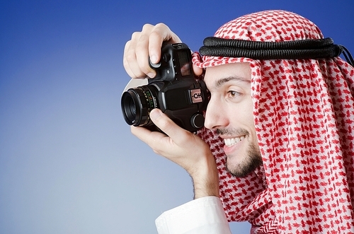 Arab photographer in studio shooting