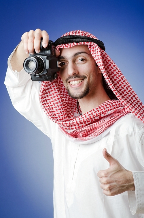 Arab photographer in studio shooting