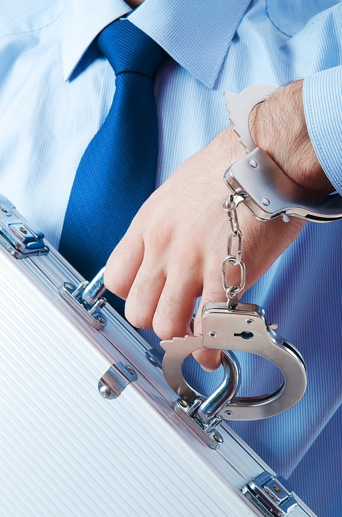 Businessman with handcuffs in concept