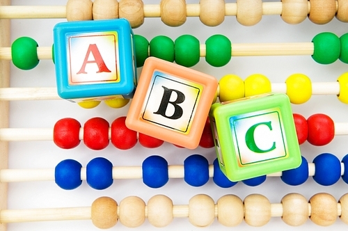 Alphabet blocks and abacus isolated on white