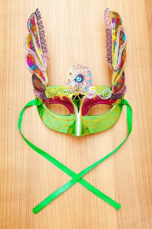 Ornate masks isolated on the wooden background