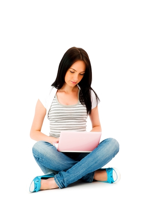 Girl working on laptop isolated on white