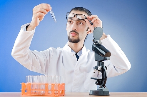 Chemist working with microscope