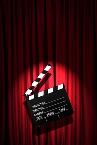 Movie clapper board against curtain