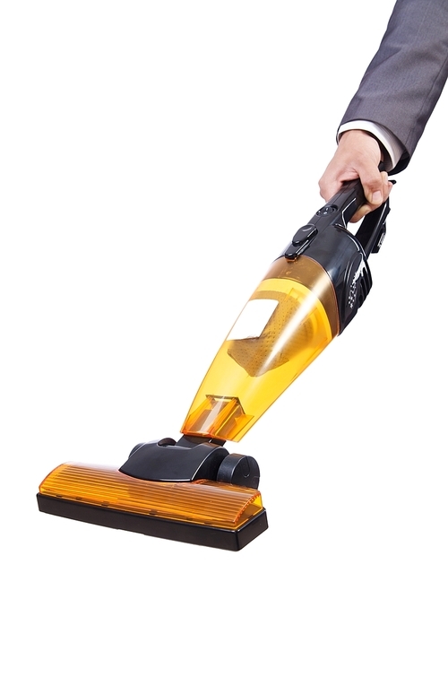 Businessman doing vacuum cleaning on white