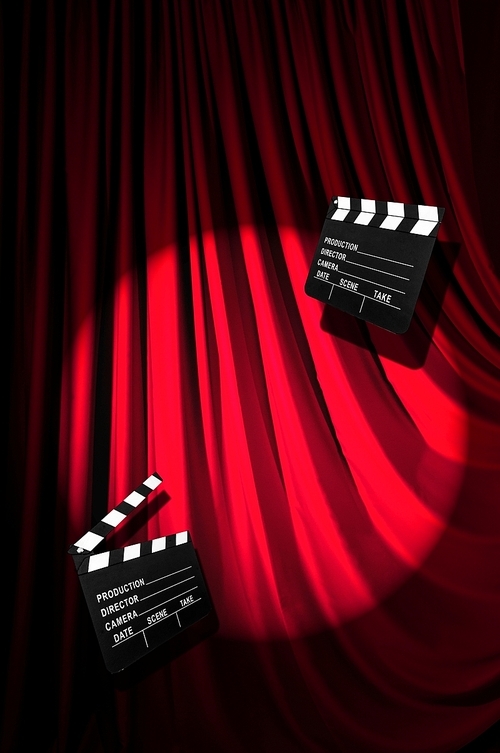 Movie clapper board against curtain