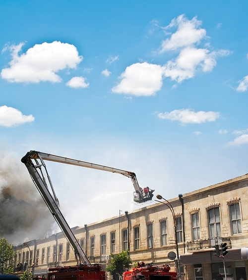 Boom of a firetruck during fire in the city