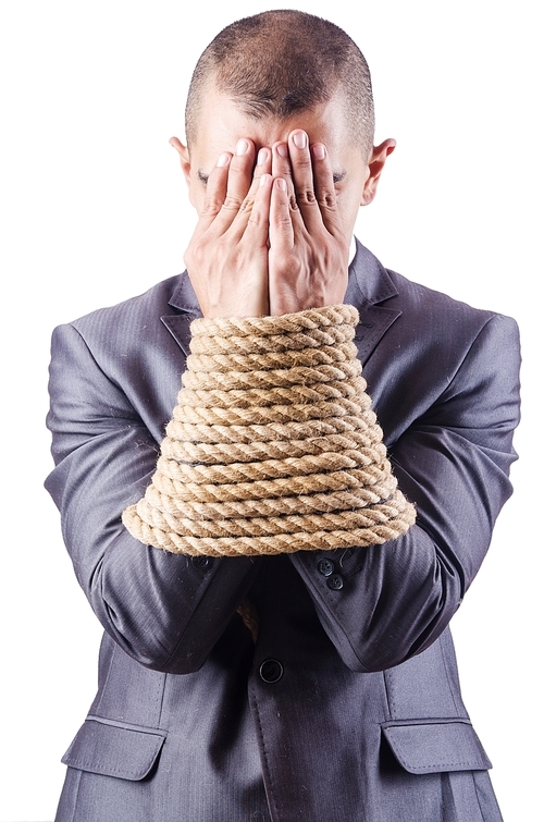 Businessman tied up with rope